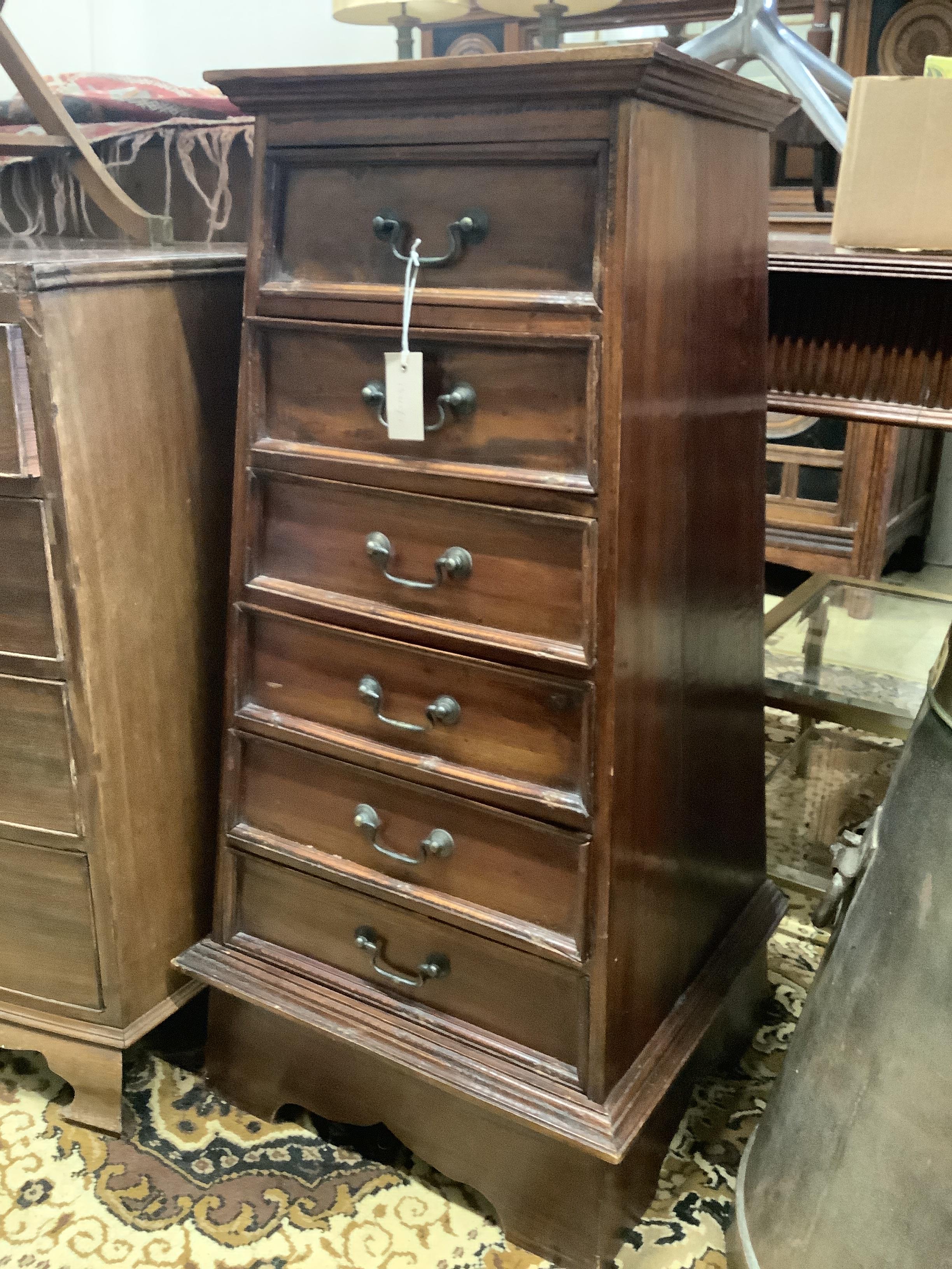 A reproduction hardwood six drawer chest of tapered form, width 36cm, depth 40cm, height 105cm